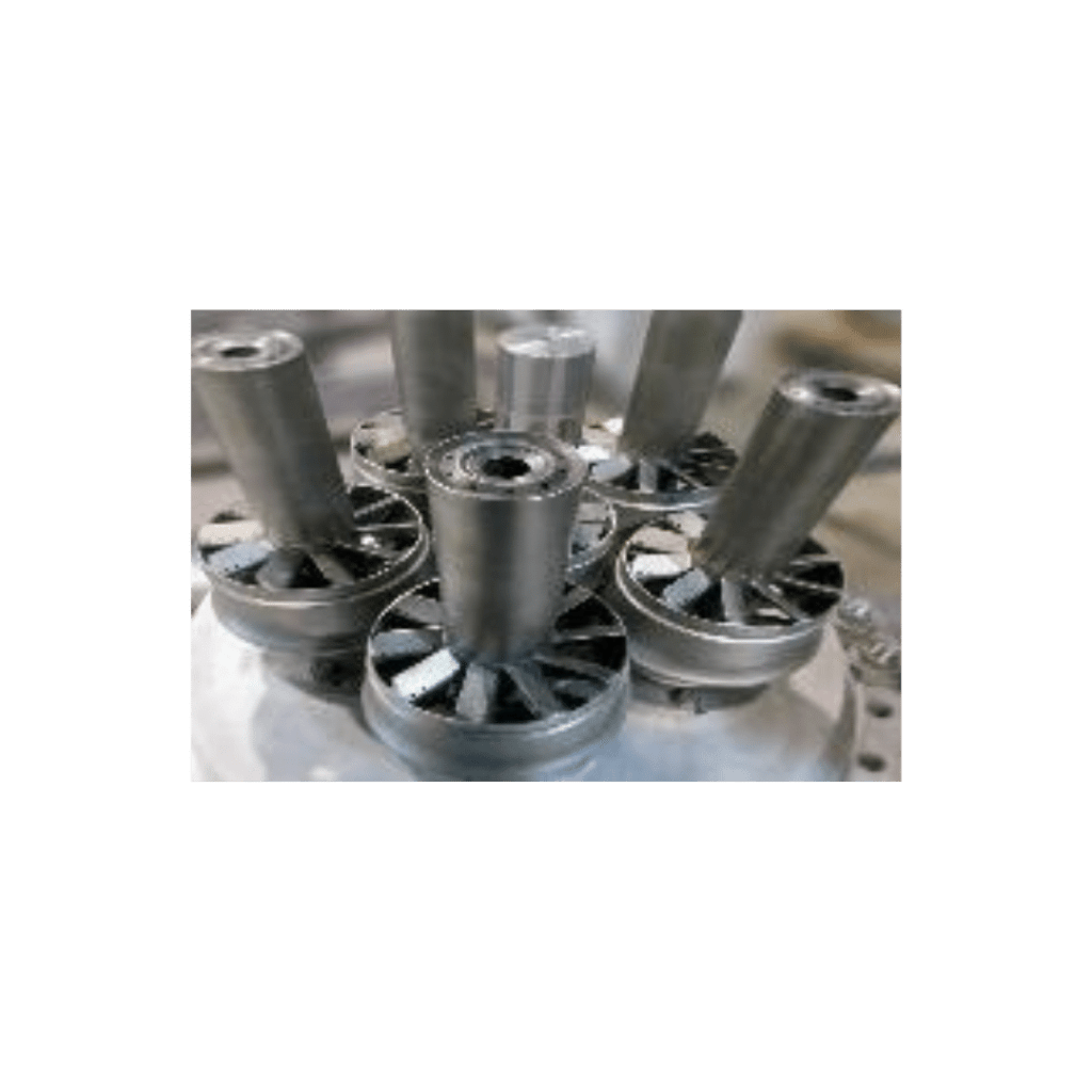 "Collection of cylindrical metal parts and gears assembled on a workshop table."