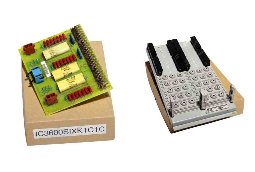 "Two industrial circuit boards placed on boxes, showcasing detailed electronic components and connectors."