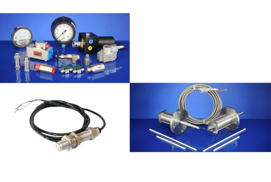 "Collection of various industrial sensors, gauges, and connectors displayed on a blue background, showcasing precision measurement equipment."